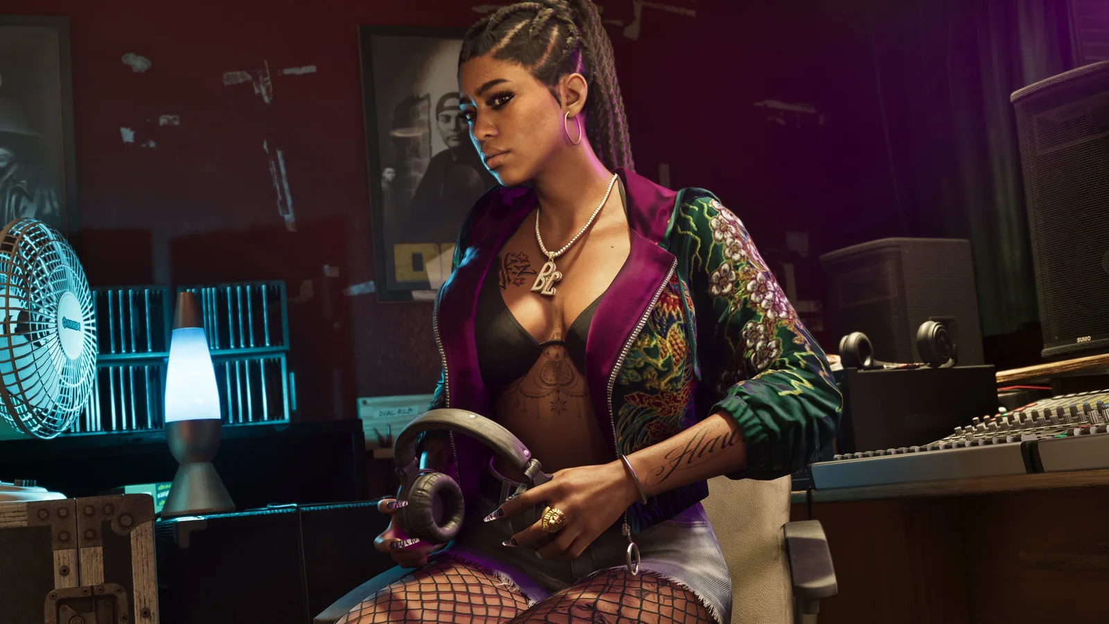 Bae-Luxe of the Real Dimez sitting in a recording studio holding headphones.