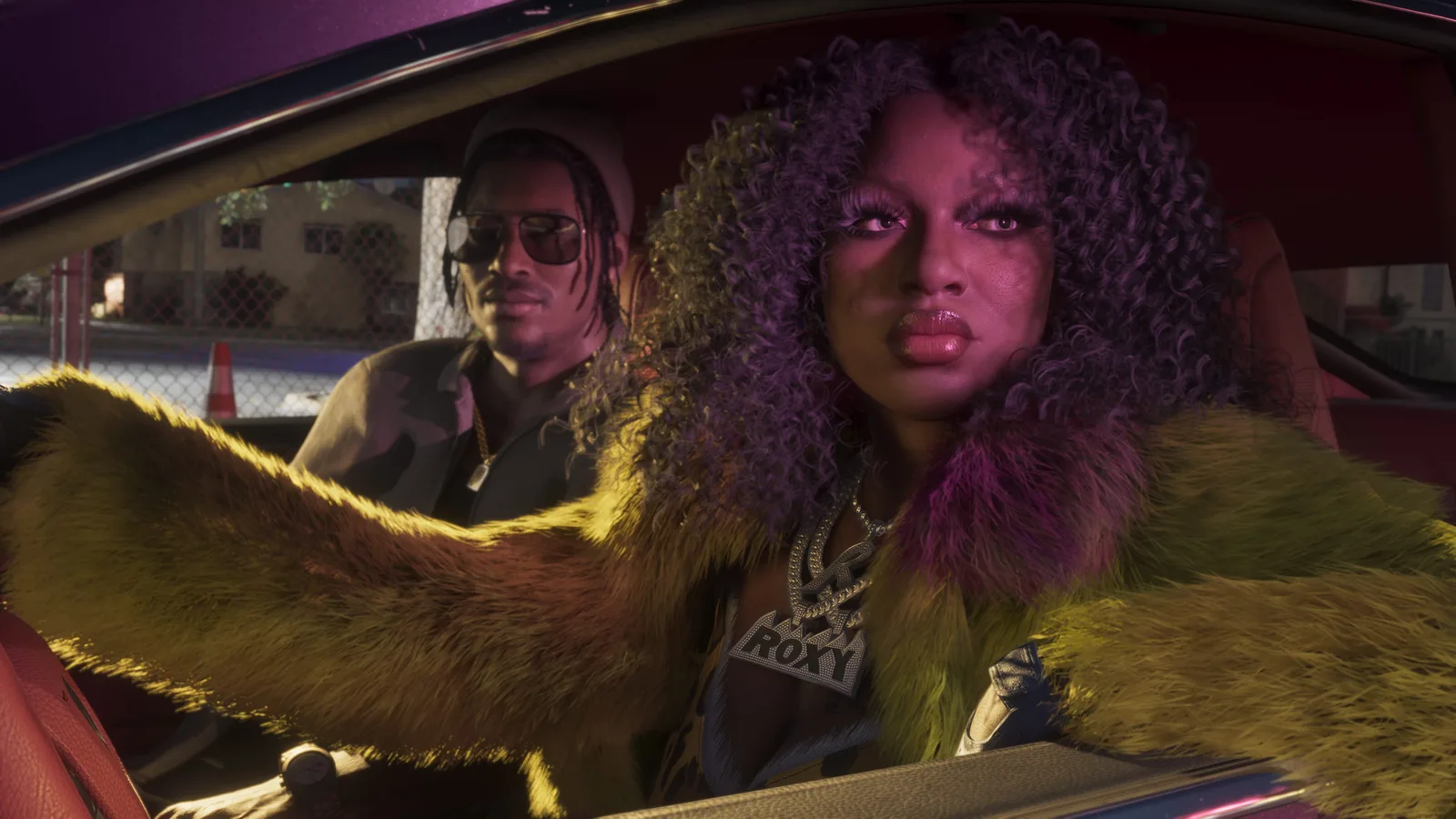 Roxy of the Real Dimez behind the wheel of a car with Dre'Quan in the passenger seat.